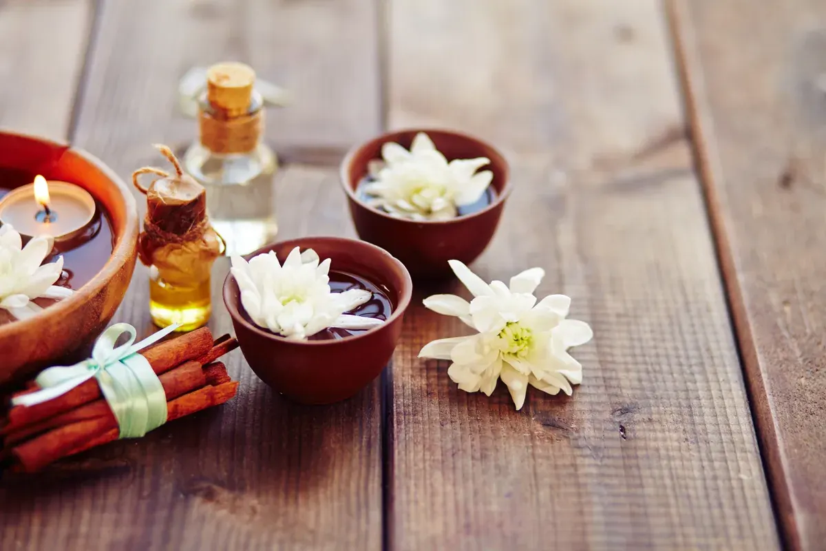 Massage oils, candles and flowers set up for a year-end function pamper station