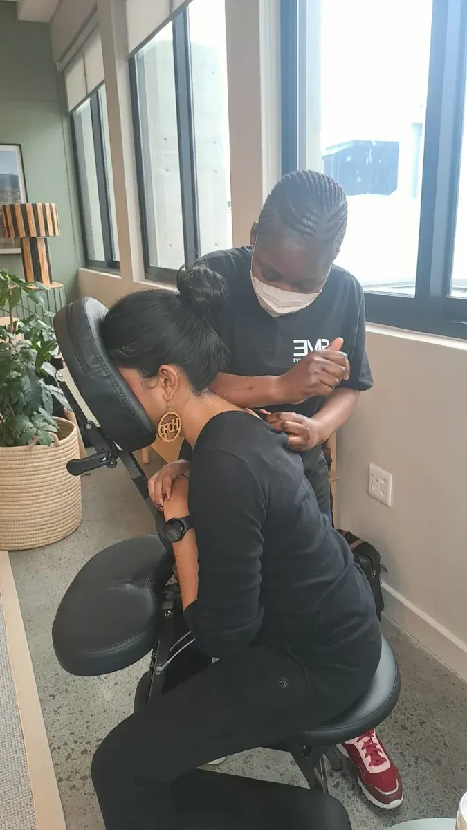 Eve Mobile Beauty therapist giving a seated chair massage at a Cape Town office function